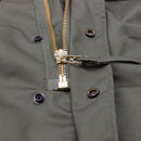 Close-up of durable olive drab fabric and brass zipper detail on MFH Brand U.S. Army style M65 field jacket parka