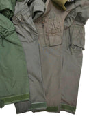 Close-up of various colored Original Dutch Army aramid carbon fiber flight suit coverall sleeves with pockets and velcro cuffs.