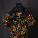 Soldier in camouflage uniform using Original Romanian army IOR 7x40 military rubberized binoculars