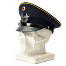 Vintage genuine German Luftwaffe Air Forces visor cap with military insignia and leather brim displayed on mannequin head.