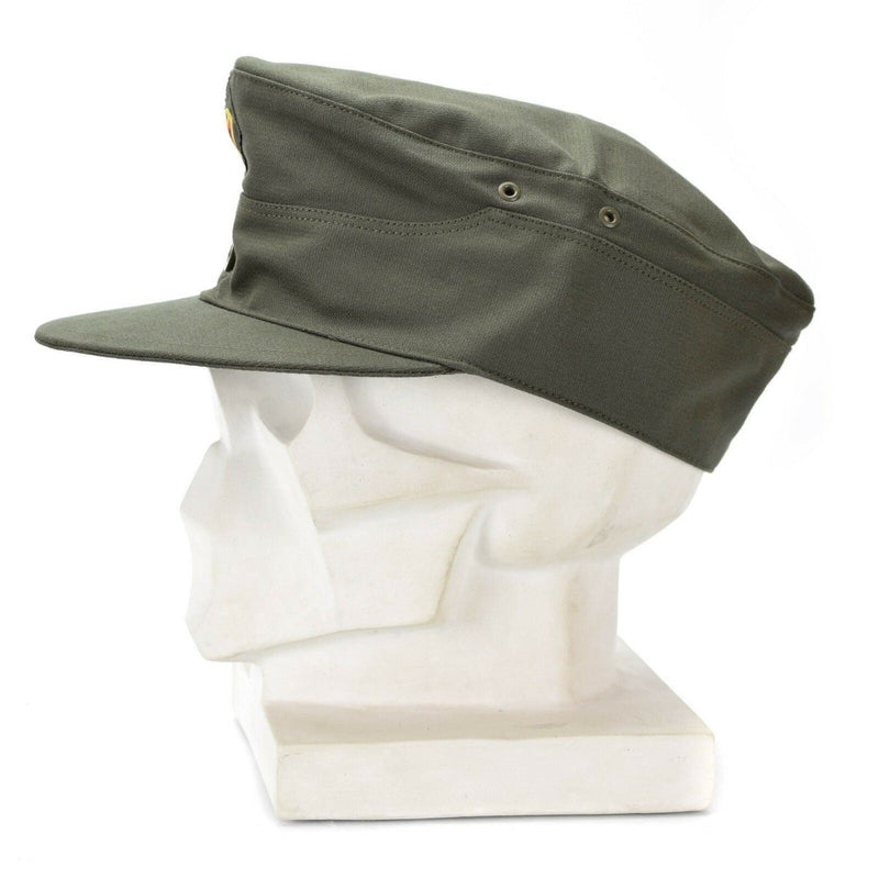 Original German Army olive green field cap with curved visor displayed on white mannequin head profile view