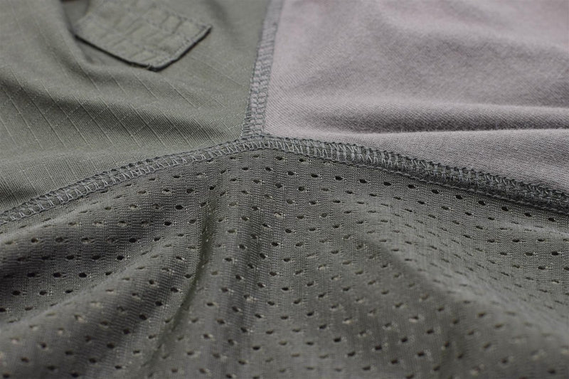 Close-up of olive MIL-TEC tactical combat shirt showing breathable mesh fabric and reinforced stitching details.