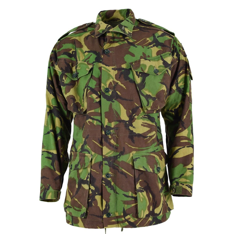 British army BDU combat smock jacket in woodland camo with multiple pockets and adjustable fit for cold weather use.