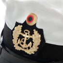 Close-up of German Navy officer's white peaked cap with gold anchor insignia and black visor band