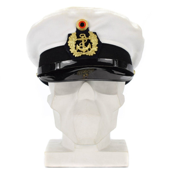 White German Navy officer's peaked cap with gold insignia and black visor displayed on a white mannequin head.