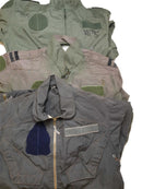 Stack of original Dutch army flight suits in various colors, made with durable aramid carbon fiber fabric and reinforced for protection