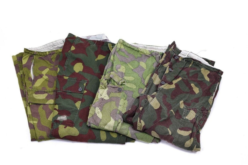 Set of Finnish M-62 reversible army camo pants in green and brown woodland patterns, durable military trousers.