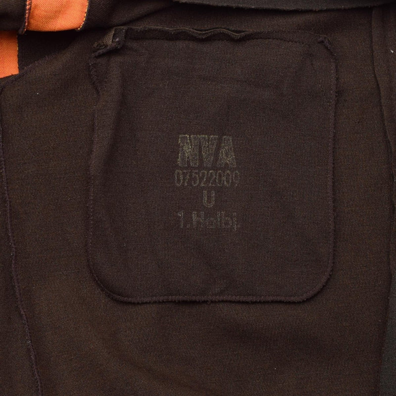 Close-up of the inside label on a brown Original German army NVA sports jacket with printed size and code details.