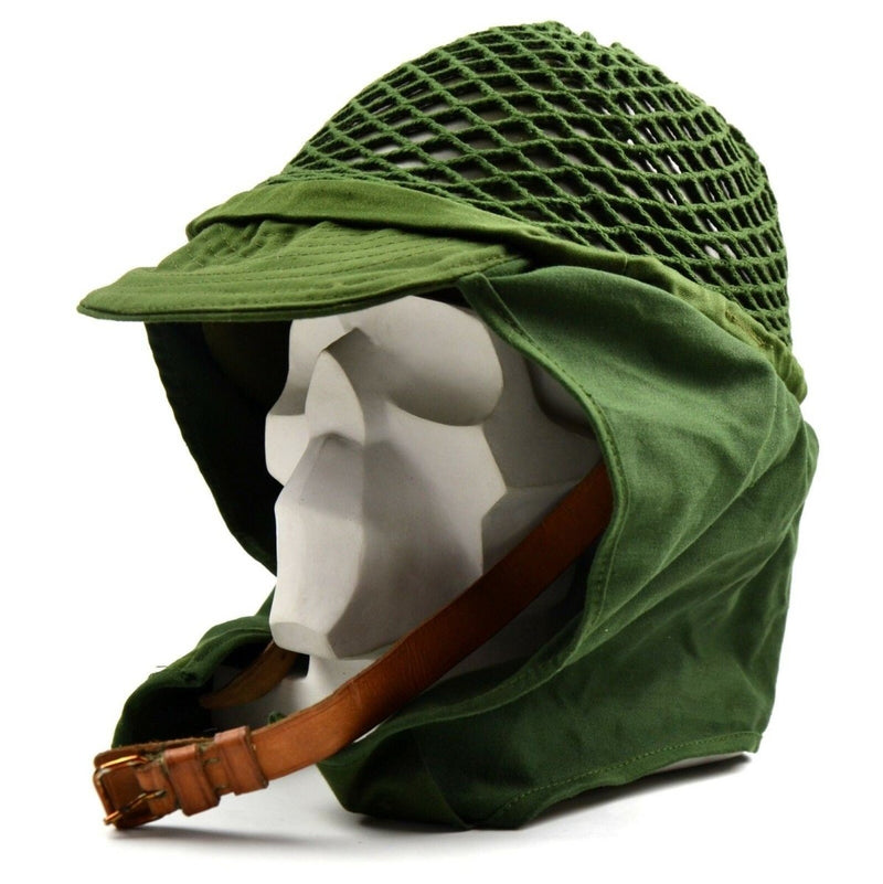 Original Swedish army military helmet with green net cover and chin strap for secure fit and camouflage