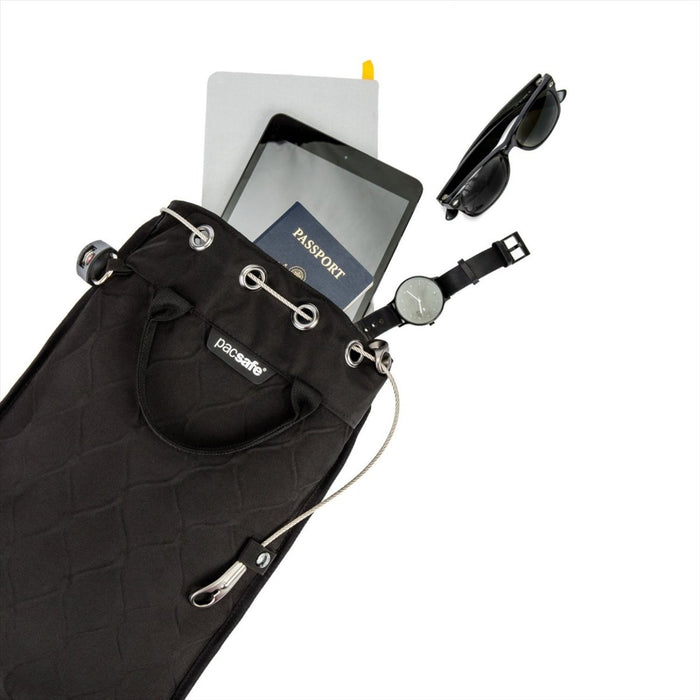 Black Pacsafe Travelsafe GII 5L portable cut-resistant travel safe bag with drawstring and travel essentials visible
