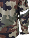Close-up of TACGEAR French military style camo commando jacket sleeve with utility pocket holding a white item